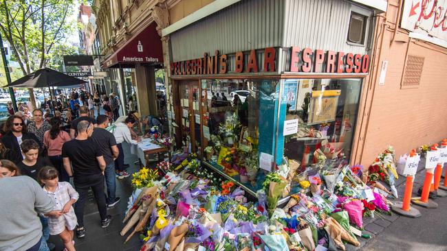 Friends, patrons and the public lay flowers outside Pellegrini’s on Bourke St in Melbourne. Picture: Jason Edwards