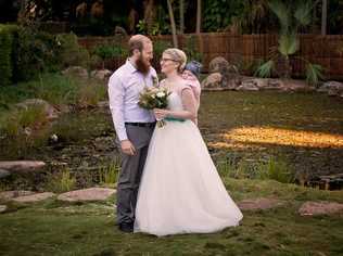 Sam and Jennifer Brown were married at the Japanese Tea Gardens at the Toondoon Botanic Garden with Braxton on Jennifer's back. Picture: Trudi G Photography