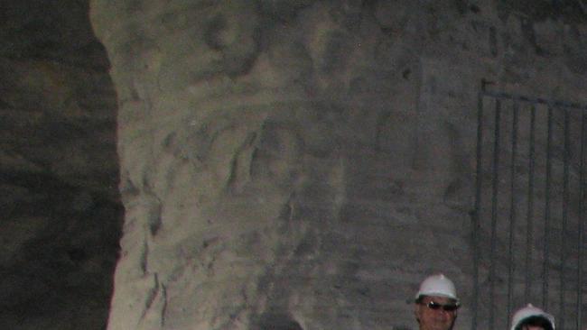 A tour group climb up the stairs within the Mount Morgan Fireclay Caverns when it was open previously.