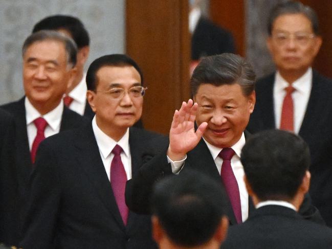 China's President Xi Jinping (C) and Premier Li Keqiang (3rd L) arrive for a reception at the Great Hall of the People on the eve of China's National Day in Beijing on September 30, 2022. (Photo by Noel CELIS / AFP)