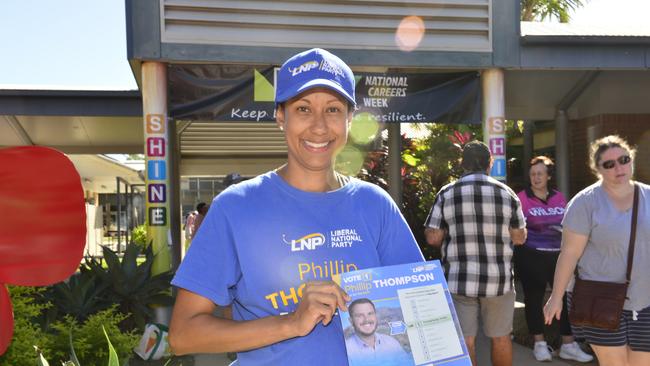 Jenna Thompson hands out how to vote cards for her husband, Phillip Thompson, at St Anthony’s Catholic College. Election day in the seat of Herbert.