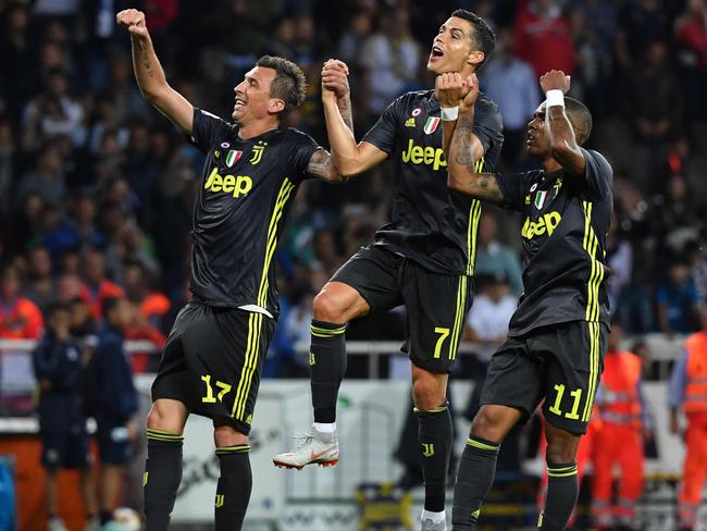 Douglas Costa celebrates with Cristiano Ronaldo. Picture: AFP