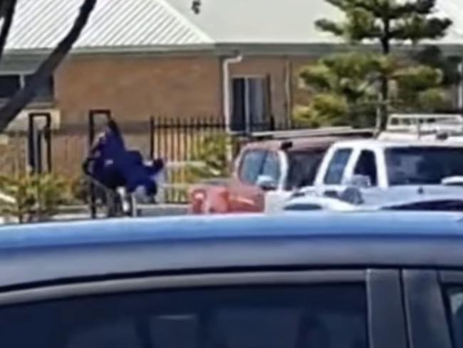 The person was seen running down the street with a Grimace sign in Lakes Entrance on Friday afternoon. Picture: Facebook/Brooke Downey