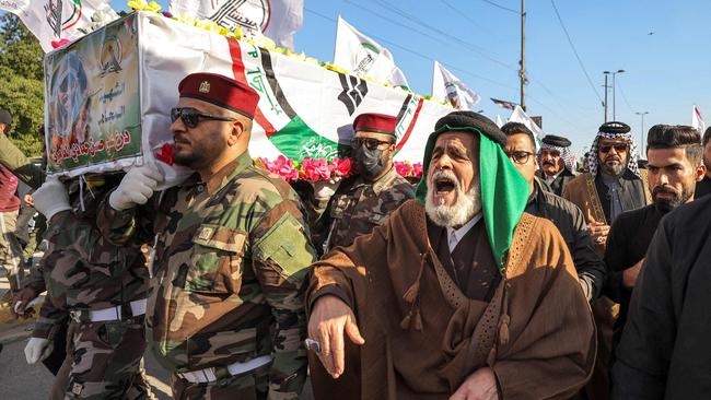 Members of the group Kataeb Hezbollah, carry the body of their fallen comrade Hassan Hammadi al-Amiri after he was killed earlier in a US airstrike. Picture: AFP.