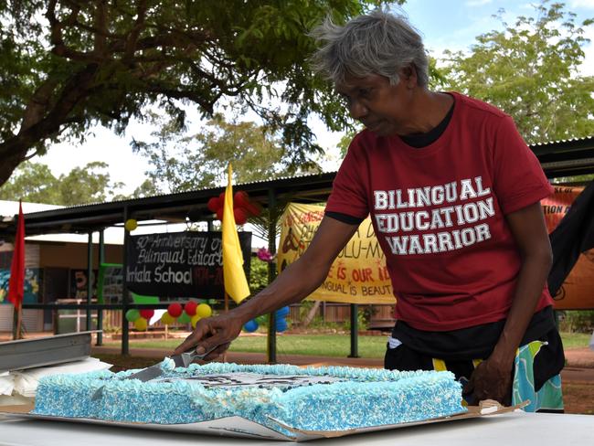 Yirrkala School co-principal Merrkiyawuy Ganambarr cuts a slice of the school’s 50th birthday cake. Picture: Sierra Haigh