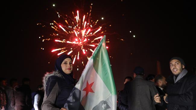 People enjoy New Year's Eve celebrations in Umayyad Square in Damascus. Picture: Getty