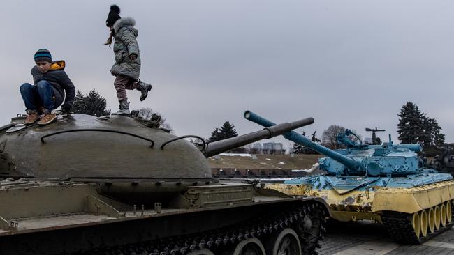 Children play on a tanks displayed at the Motherland Monument on the newly created "Unity Day" on February 16, 2022, in Kyiv, Ukraine. Picture: Chris McGrath/Getty Images