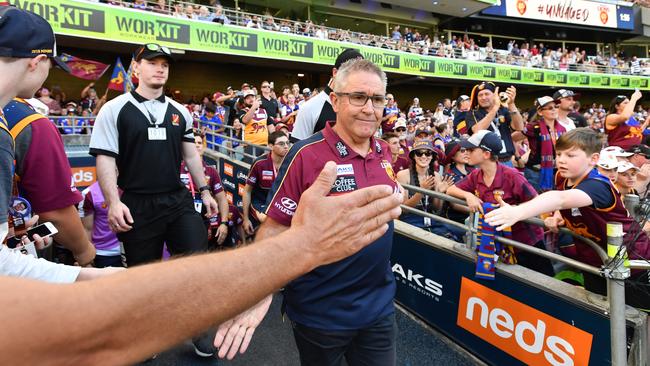 Lions coach Chris Fagan gives a fan a high-five last week. Picture: AAP