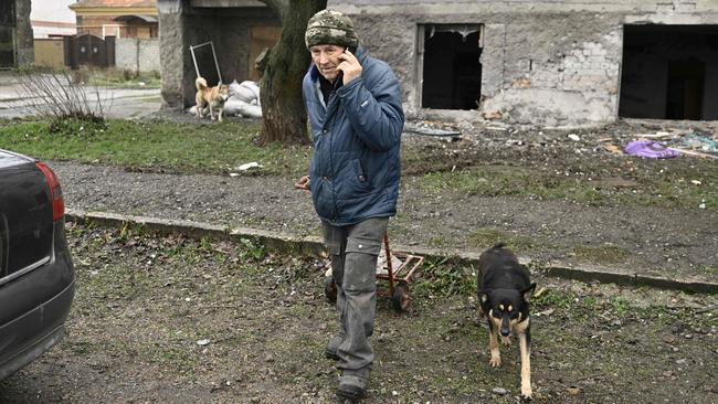 A local resident walks in front of a multi-storey building, damaged following recent attack in the town of Ochakiv. Picture: AFP