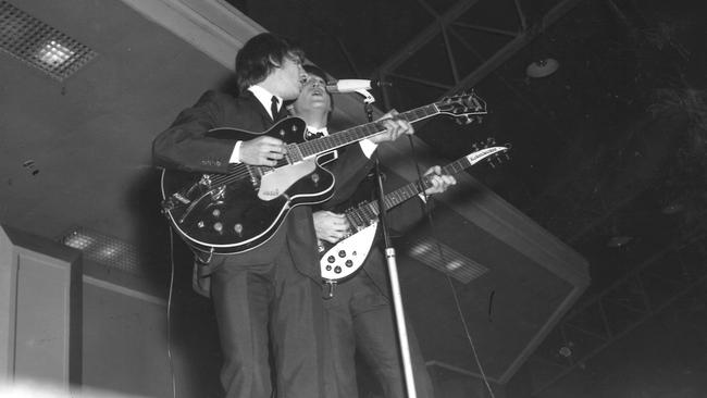 The Beatles members George Harrison and John Lennon perform at Melbourne’s Festival Hall. Picture: Herald and Weekly Times archive