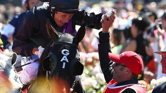 Damien Oliver celebrates after the Melbourne Cup victory. Picture: George Salpigtidis