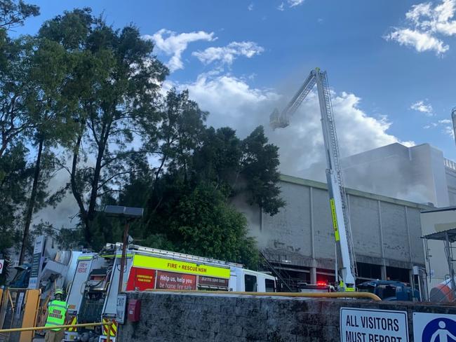 Firefighters battling a blaze in Artarmon on Monday were forced to pause operations when the lighning storm rolled across Sydney. Picture: Fire and Rescue NSW