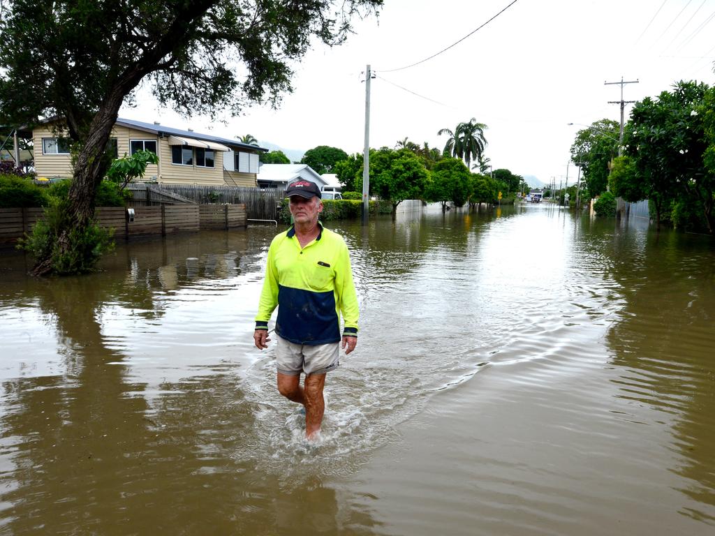 Hermit Park resident Ross Cribbin walks through a still-flooded part of Hodel St. Picture: Evan Morgan