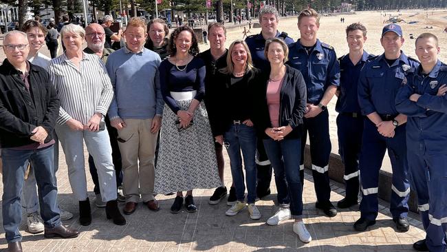 Katherine Smith (centre), of Kurraba Point, on Tuesday, with members of the public and NSW Ambulance paramedics who combined to save her life after she stopped breathing while on an early morning swim to Shelly Beach. Left to right: Husband Stuart Smith, son Saxon, Frances Russell, Neutral Bay, Gary Russell, Neutral Bay, David Livermore, North Sydney, Edwina Harrison, Manly Vale, Dr Kate Schofield, Pymble, Gary Ingle, Balgowlah Heights and Melissa Pye, Neutral Bay with Ambulance paramedics Paul, Brodie, Locky, Christian and Max. Picture: NSW Ambulance