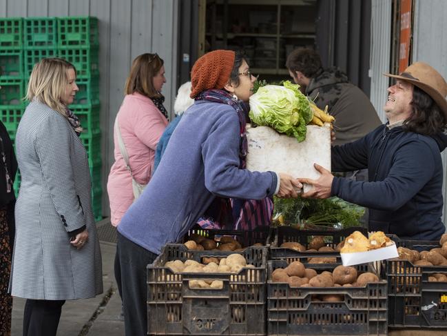 Vegetable grower Sandor Istella serving customers at Bendigo Community Farmers' Market. Picture: Zoe Phillips