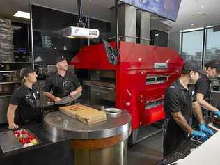 Dominos CEO Nick Knight and the new high-tech Pizza Checker. Picture: Supplied