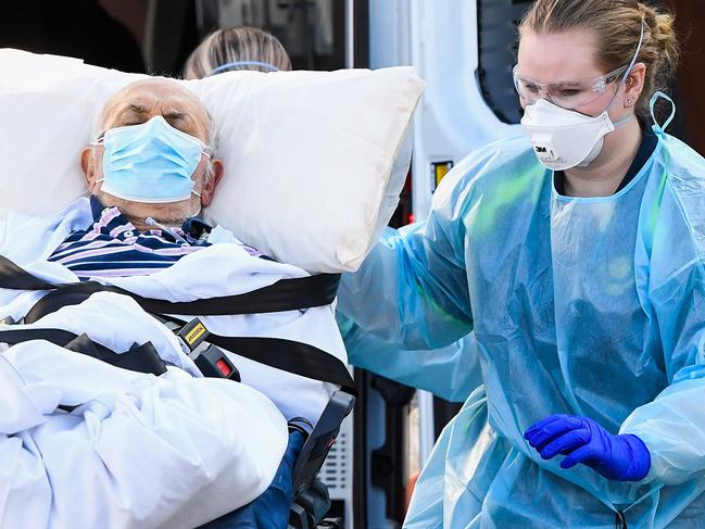 Ambulance officers transport a resident from the Epping Gardens aged care facility in the Melbourne suburb of Epping on July 29, 2020, as the city battles fresh outbreaks of the COVID-19 coronavirus. (Photo by William WEST / AFP)