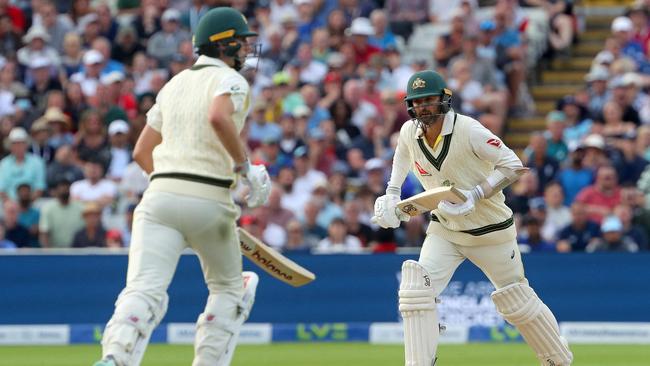 Pat Cummins (L) and Nathan Lyon add runs on day five of the first Ashes cricket Test match. Picture: AFP.