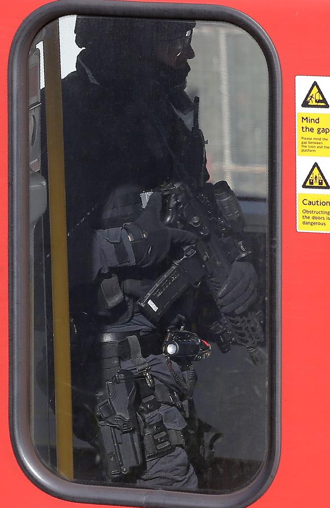 Armed British police officers walk through the carriage of a London underground tube carriage at Parsons Green underground. Picture: AFP