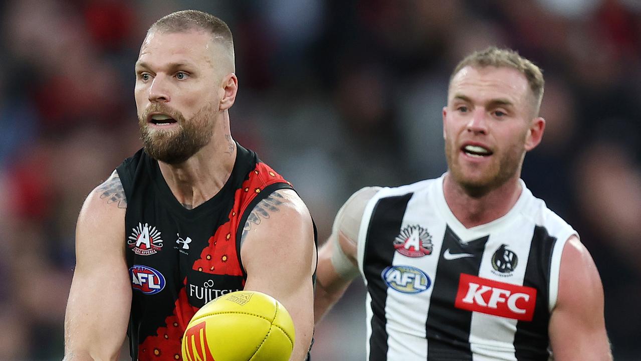 MELBOURNE, APRIL 25, 2024: 2024 AFL Football Round 7 - Anzac Day Match - Essendon V Collingwood at the MCG. Jake Stringer under pressure from Tom Michell. Picture: Mark Stewart