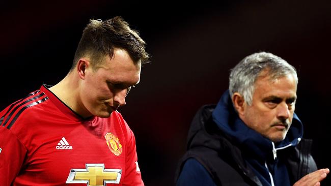 Jose Mourinho (R) and a shattered Phil Jones. Picture: Getty