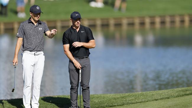 PONTE VEDRA BEACH, FLORIDA - MARCH 14: Jordan Spieth of the United States and Rory McIlroy of Northern Ireland look on from the 16th green during the first round of THE PLAYERS Championship on the Stadium Course at TPC Sawgrass on March 14, 2024 in Ponte Vedra Beach, Florida. (Photo by Mike Ehrmann/Getty Images)