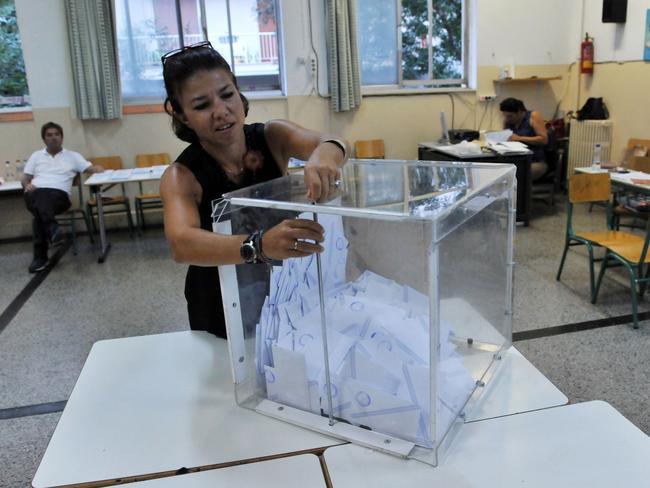 An election official opens a ballot box to count the votes at a polling station in Thessaloniki. Political commentators asserted ‘election fatigue’ was responsible for a lower voter turnout. Picture: AFP PHOTO / SAKIS MITROLIDIS