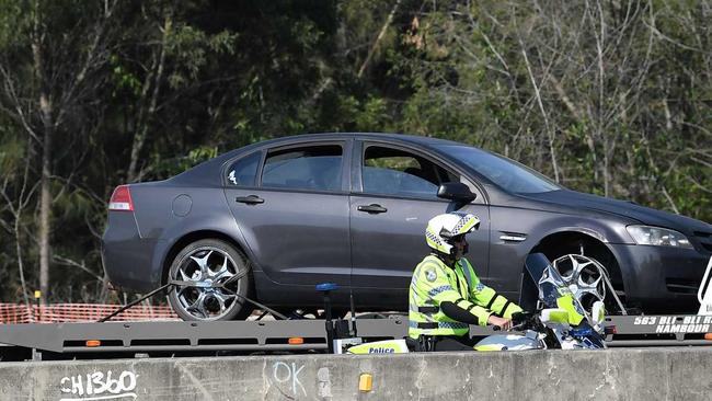 A Holden Commodore crashed on the Bruce Highway at Sippy Downs after a high-speed police chase along the Bruce Highway from Gympie. Photo: Patrick Woods. Picture: Patrick Woods