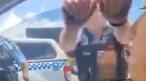 A sovereign citizen is dragged from her car by police. Picture: Supplied