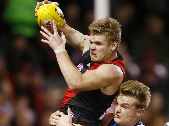 AFL Round 17. Essendon vs Port Adelaide at Etihad Stadium. Michael Hurley is tackled by Ollie Wines as he akes possession of the bouncing ball . Pic: Michael Klein