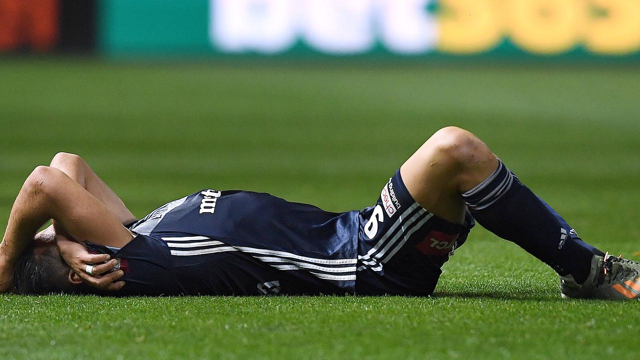 Andrew Nabbout slumps to the ground after the final whistle in Melbourne Victory’s 3-1 loss to Adelaide United.