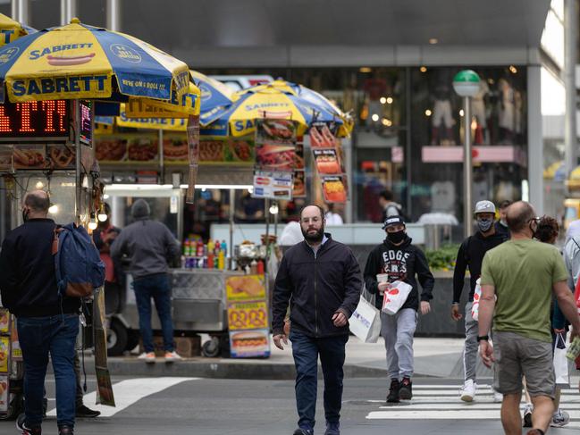 A man without a mask crosses a street in Manhattan, New York. Picture: AFP