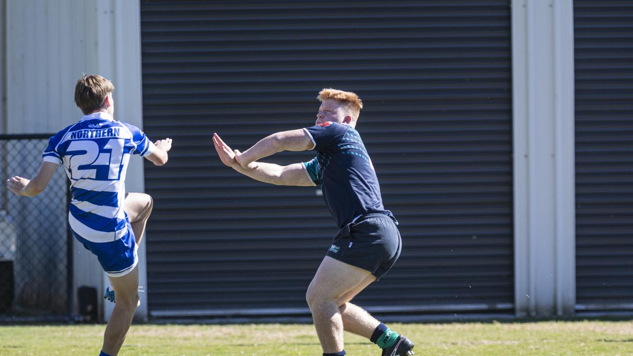 Indygo Keir of Northern kicks under pressure from Manaaki Bateman of Met North.