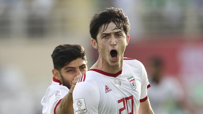 Iran's forward Sardar Azmoun, right, celebrates after scoring his side's second goal during the AFC Asian Cup group D soccer match between Iran and Vietnam at Al Nahyan Stadium in Abu Dhabi, United Arab Emirates, Saturday, Jan. 12, 2019. (AP Photo/Kamran Jebreili)