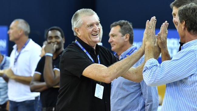 Former Bullets coach Brian Kerle (centre) is seen with members of the Bullets championship-winning sides of 1985 and 1987 at a half time presentation during a Brisbane NBL game in 2018. (AAP Image/Darren England)