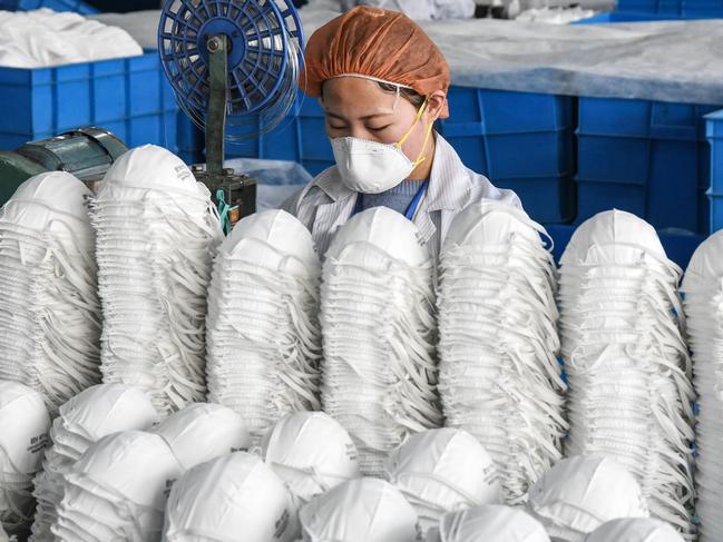 A worker producing face masks at a factory in Handan in China's northern Hebei province. Picture: AFP