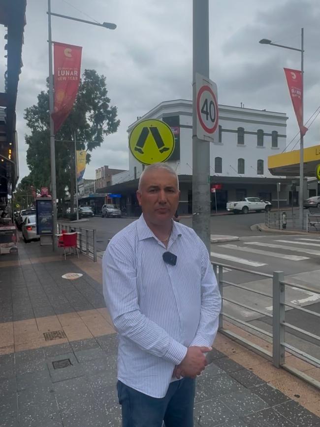 Cumberland councillor Steve Christou at South St, Granville, in front of Lunar New Year banners.