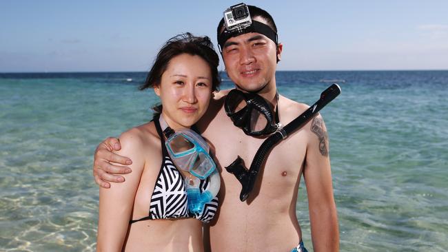 Chinese tourists Monique Liu and her boyfriend Enzo Cheng enjoy the sunshine of Green Island in the Great Barrier Reef. Picture: Brendan Radke/News Corp Australia