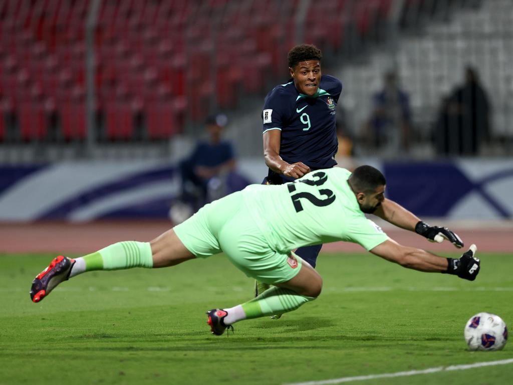 Kusini Yengi slides the ball past Bahrain goalkeeper Ebrahim Lutfalla to give Australia the lead. Picture: Christopher Pike/Getty Images