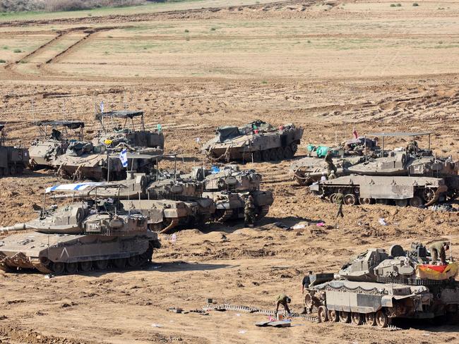 Israeli troops gather with their military vehicles on the border with the Gaza Strip. Picture: AFP