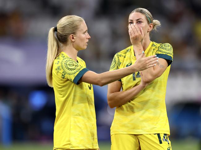 MARSEILLE, FRANCE – JULY 31: Kaitlyn Torpey and Alanna Kennedy #14 of Team Australia look dejected following the Women's group B match between Australia and United States during the Olympic Games Paris 2024 at Stade de Marseille on July 31, 2024 in Marseille, France. (Photo by Alex Livesey/Getty Images)