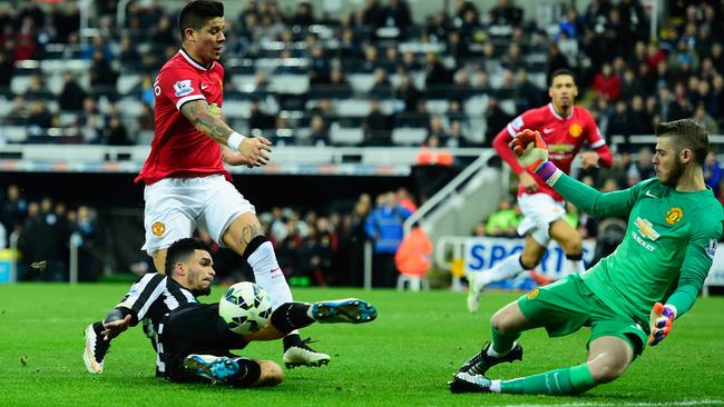 Manchester United’s David De Gea thwarts Emmanuel Riviere.