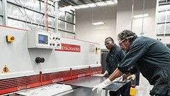 Inmates build office cabinets.