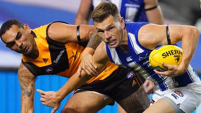 Shaun Higgins of the Kangaroos and Shaun Burgoyne of the Hawks compete for the ball during the Round 4 AFL match between the Hawthorn Hawks and the North Melbourne Kangaroos, Sunday, June 28, 2020. (AAP Image/Scott Barbour)