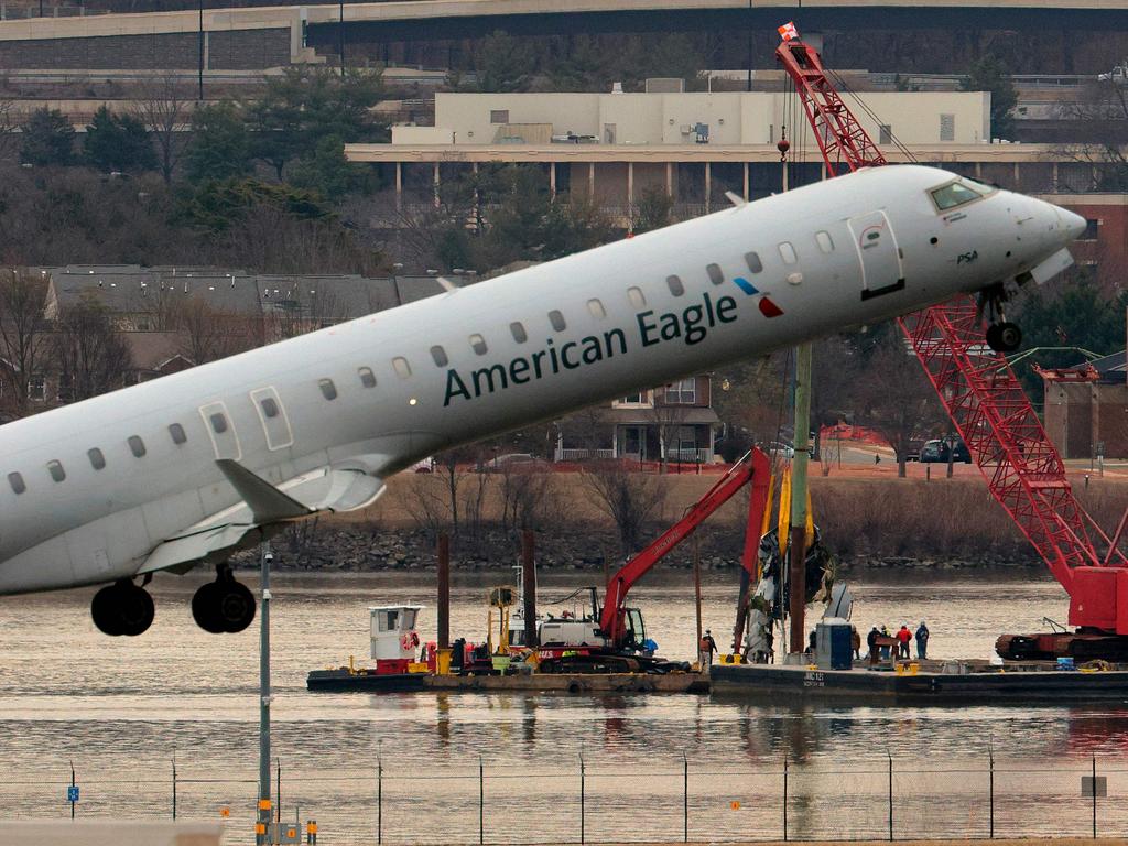 A plane lifts off from Reagan National Airport near Washington DC as a crew works to remove debris from of the Potomac River during recovery efforts. Picture: Getty Images via AFP