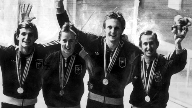 Mark Kerry, Peter Evans, Neil Brooks, and Mark Tonelli wearing gold medals.