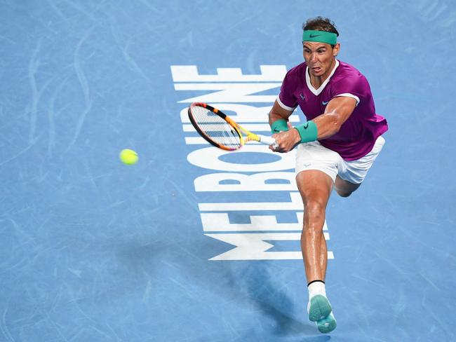 Spain's Rafael Nadal hits a return against Russia's Daniil Medvedev during their men's singles final match on day fourteen of the Australian Open tennis tournament in Melbourne on January 30, 2022. (Photo by William WEST / AFP) / -- IMAGE RESTRICTED TO EDITORIAL USE - STRICTLY NO COMMERCIAL USE --