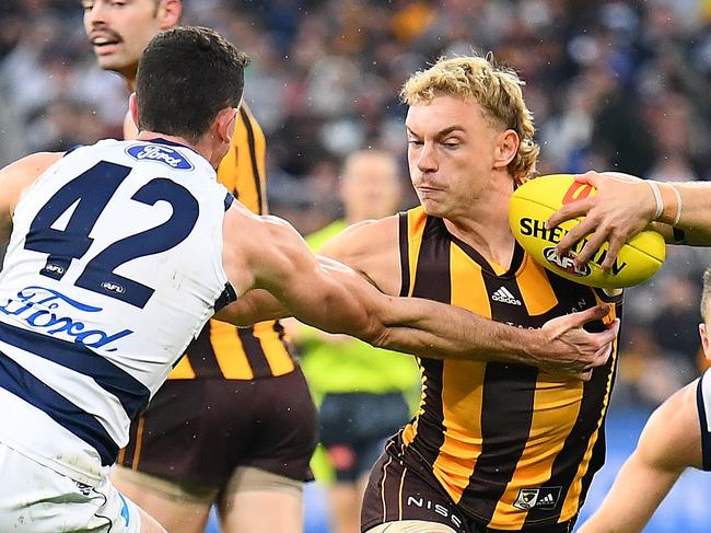 MELBOURNE, AUSTRALIA - APRIL 18: James Worpel of the Hawks fends off a tackle by Mark O'Connor of the Cats during the round five AFL match between the Hawthorn Hawks and the Geelong Cats at Melbourne Cricket Ground on April 18, 2022 in Melbourne, Australia. (Photo by Quinn Rooney/Getty Images)