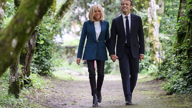 Emmanuel and Brigitte Macron in the park of Chateau de Ferney-Voltaire, in Ferney-Voltaire. Picture: AFP.