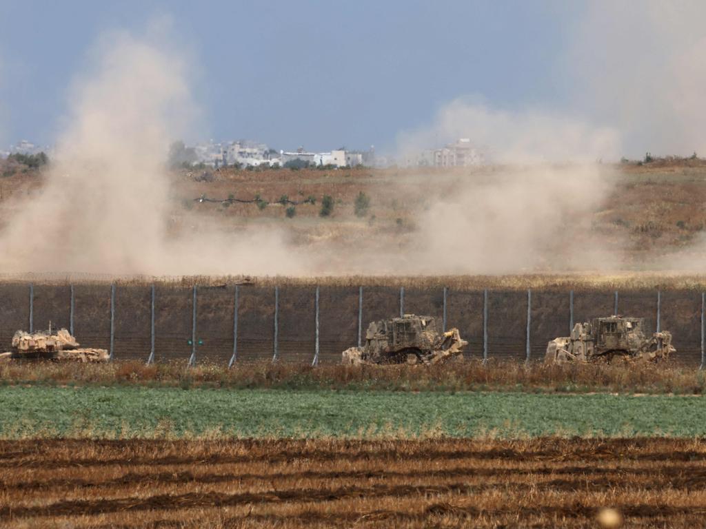 Israeli military vehicles roll near the border with the Gaza Strip on May 12. Picture: Menahem Kahana/AFP